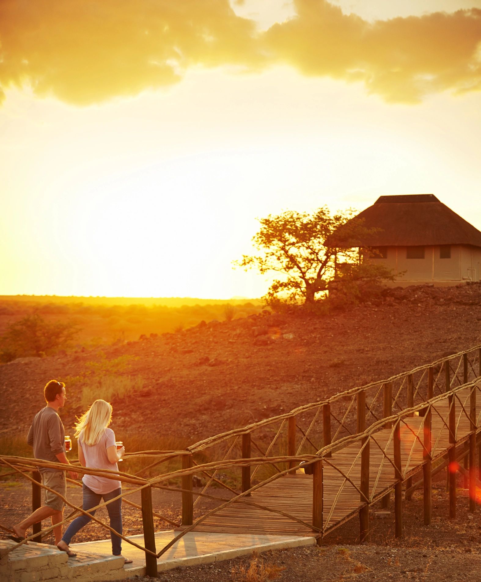 Luxury safari camp with warm lantern light at dusk